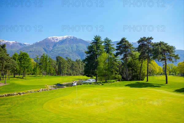 Hole 8 in Golf Club Ascona with Trees and Mountain in Ticino