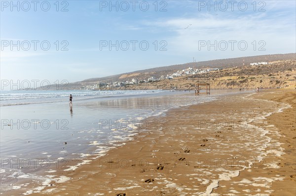 Sandy beach at low tide near village of Taghazout