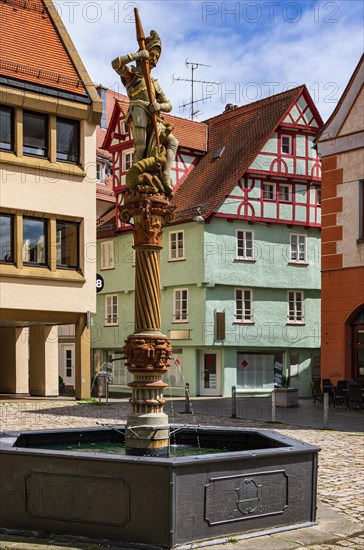 Quiet and deserted scene in front of the Georgsbrunnen with St. George drilling a lance into the throat of a lindworm