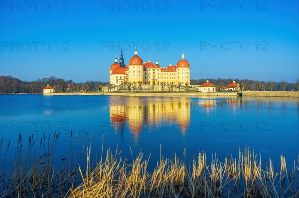 Exterior view of Moritzburg Castle in winter with half-frozen castle pond from the southwest