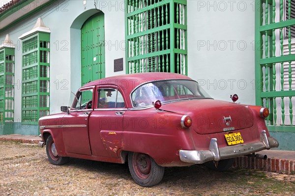 Pastel coloured houses with barrotes and old 1950s vintage American car