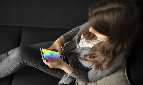 Subject: Teenagers with mobile phones on the sofa