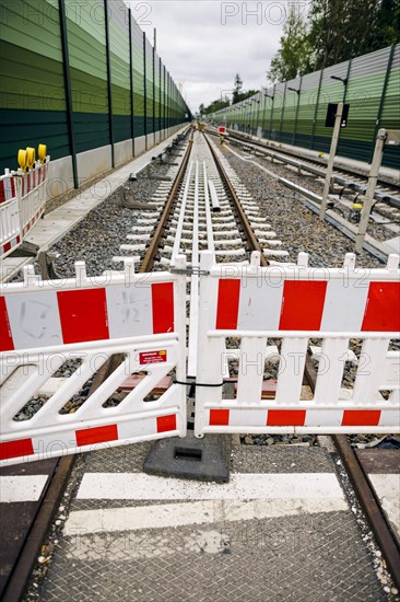 Symbolic photo on the subject of railway infrastructure. A barrier of a construction site stands on a newly built track at Lichtenrade station. Berlin