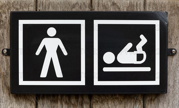 Male toilet sign with baby nappy diaper changing facility