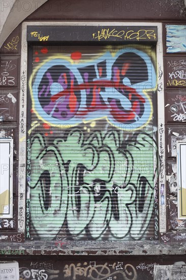 Colourful graffiti on a shutter of a window