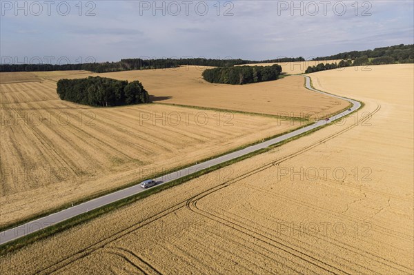 Aerial view of a country road with a car in Koenigshain in Saxony.