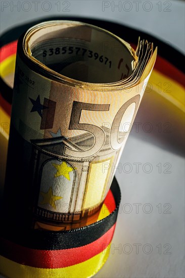 Symbolic photo on the subject of cash. 50 euro notes are framed by a band in black