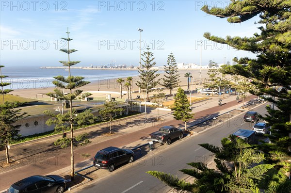Raised view over sandy beach towards fishing port