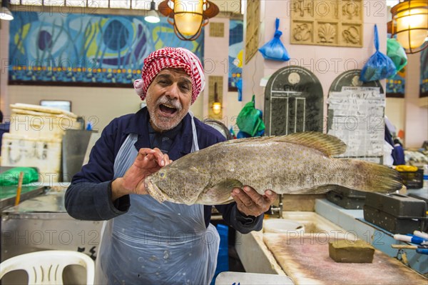 Local fisher man showing his fish