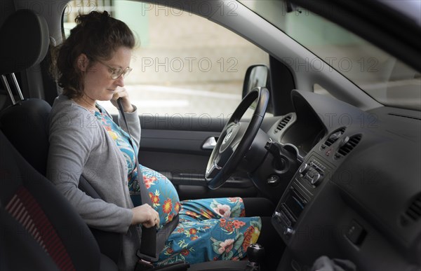 Subject: Pregnant woman wearing a seat belt in the car