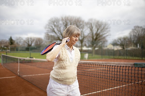 Subject: Woman aged 82 standing on the tennis court