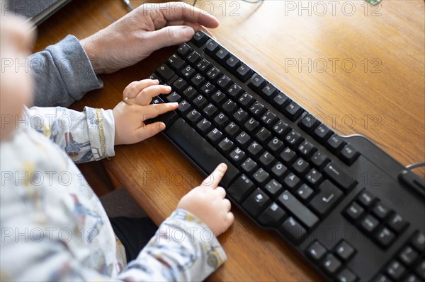 Subject: Man in a home office and a small child