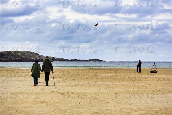 Pedestrians on the sandy beach