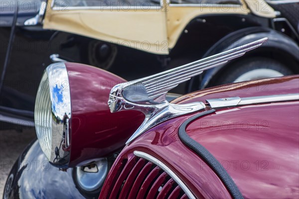 Close up of silver female figure hood ornament on Citroen classic car