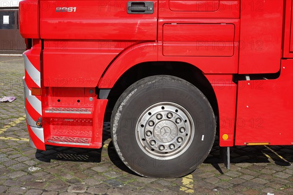 Wheel and tyre on a red Mercedes truck