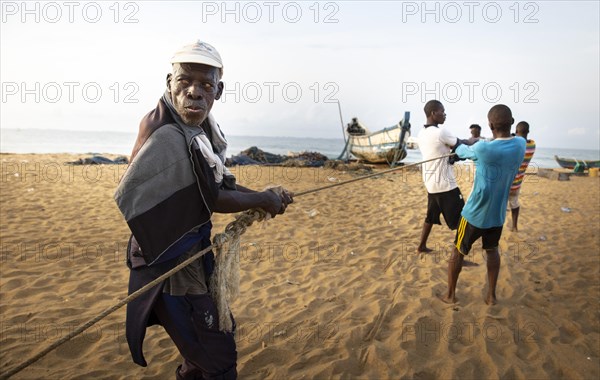 Old fisherman helps to land a catch