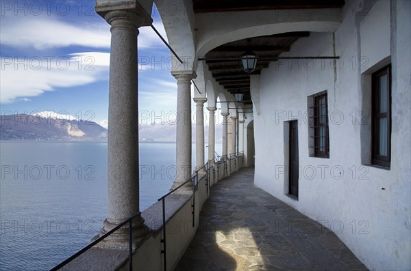 Eremo di Santa Caterina del Sasso on the Lake Maggiore with Snow-capped Mountain in Leggiuno in Lombardy