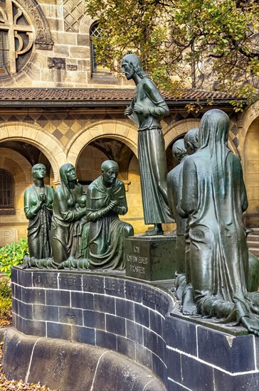 Group sculpture of the consoling Christ by Selmar Werner at the fountain in the courtyard of the Church of Reconciliation in Dresden