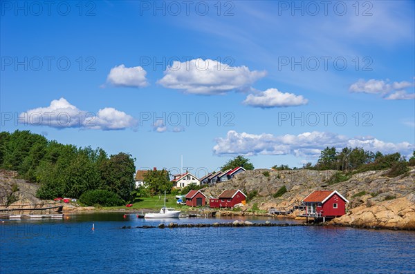 Picturesque rocky coast with small settlement and marina on an offshore island