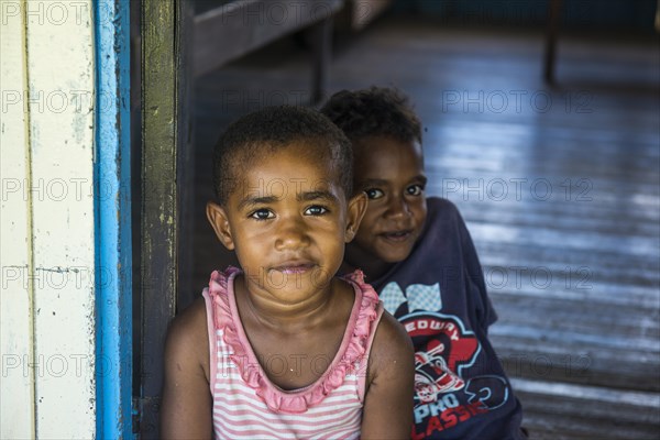 School kids sitting in the entrance of a school