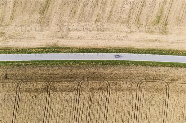 Aerial view of a country road with a car in Koenigshain in Saxony.