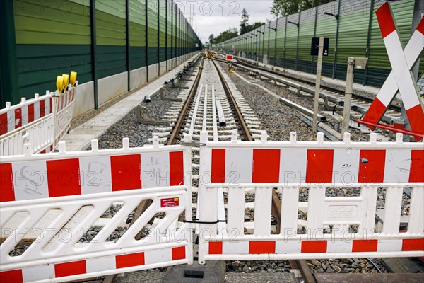 Symbolic photo on the subject of railway infrastructure. A barrier of a construction site stands on a newly built track at Lichtenrade station. Berlin