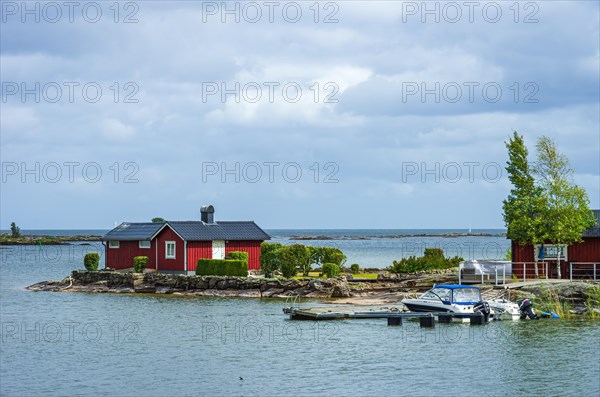 Small boats and picturesque shore landscape at the edge of Lake Vaenern in the area of Sunnana