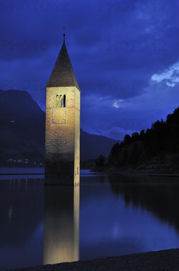 The submerged church tower at night in Lago di Resia at Curon Venosta