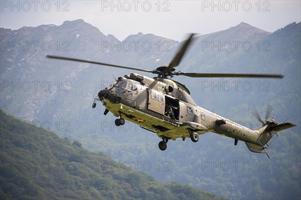 Swiss Air Force Helicopter Against Mountain in Switzerland
