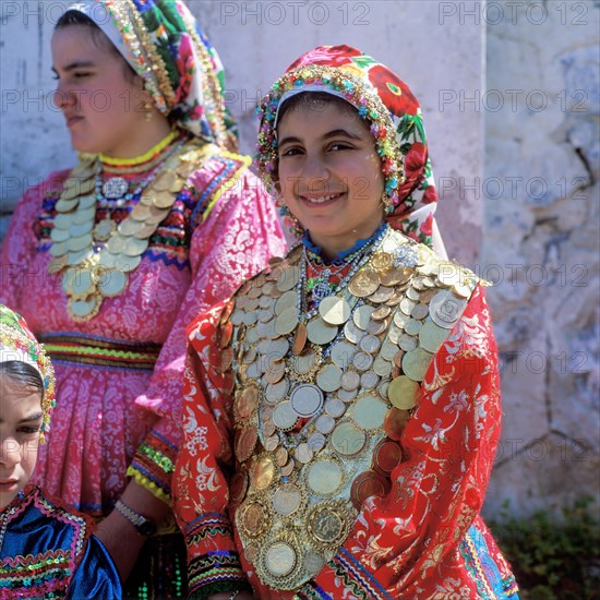 Girls decorated with gold coins