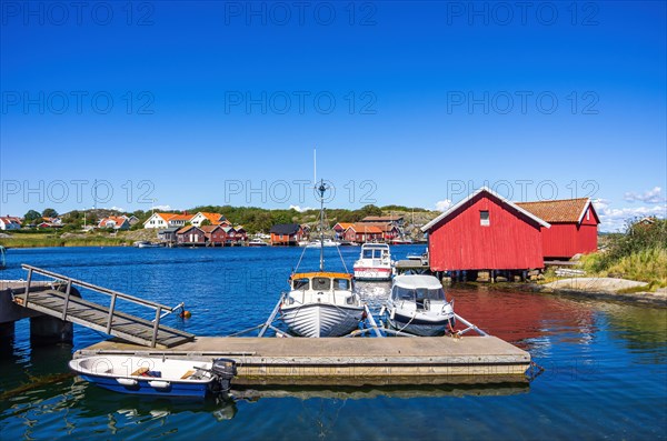 Mooring with boats and boathouses in the picturesque village of Langegaerde