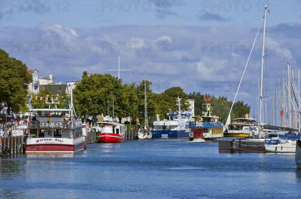 Fishing boats and excursion ships at the Alter Strom in Rostock-Warnemuende