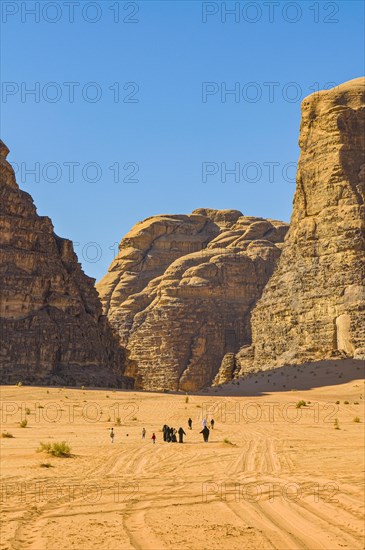 Bedouins with camels in desert