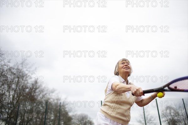 Subject: Woman aged 82 standing on the tennis court