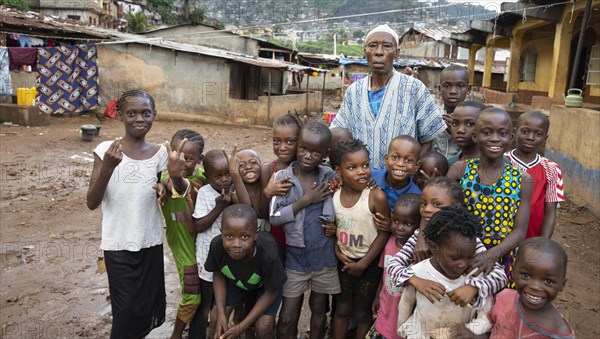 Old man with children in Bomeh Village at KissyRoad dumpsite