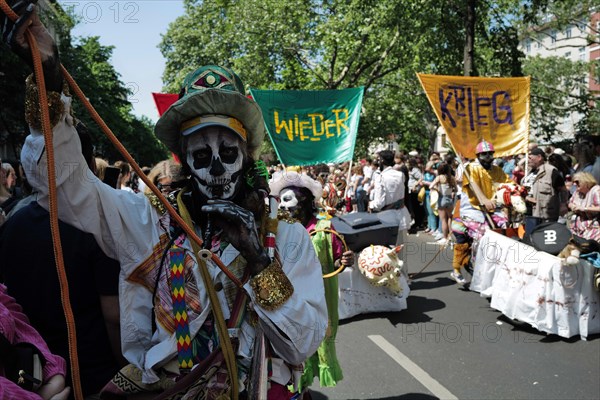 An anti-war participant entertains the crowd before the start of the Carnival of Cultures in Berlin. The event passed off in glorious sunshine this afternoon as Berlin residents enjoyed the good Whitsun weather