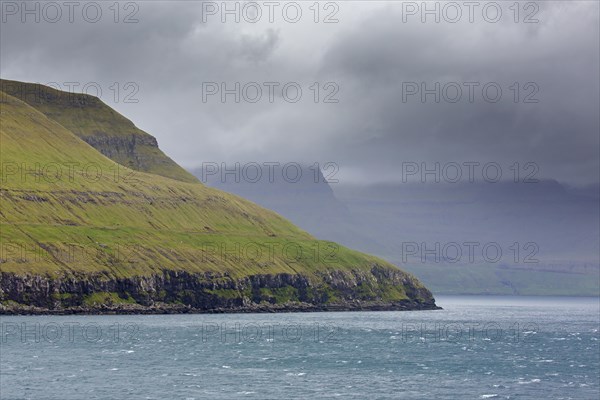 Sea cliffs along the rugged coast of Eysturoy