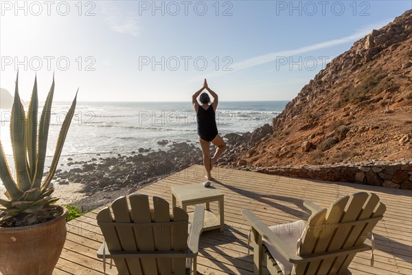 Woman performing yoga Tree pose Vrikshasanayoga