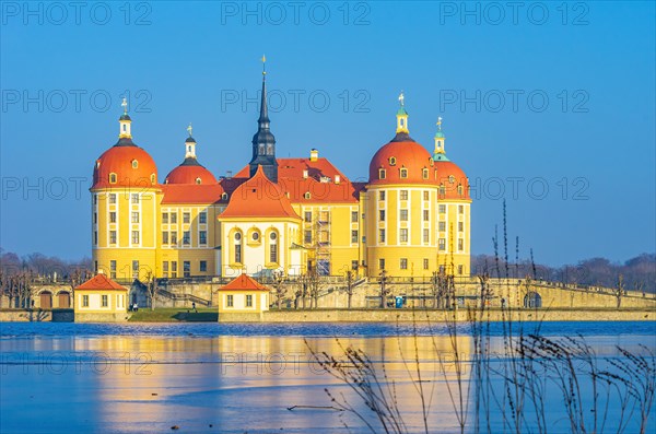 Exterior view of Moritzburg Castle in winter with half-frozen castle pond from the west