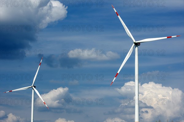 Two wind turbines in summer towering into the sky in Brandenburg near Luckau