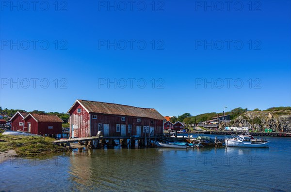 Picturesque view of maritime structures of boathouses and boats in the village of Langegaerde