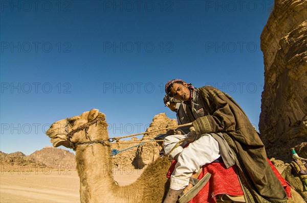 Bedouins with camels in desert