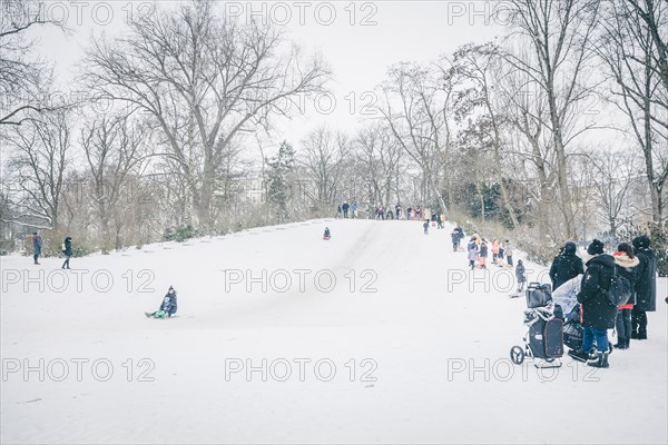 People tobogganing on a small mountain in Kreuzberg in Berlin in the snow. 09.02.2021.