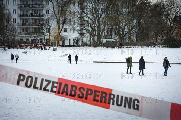 People walk on the frozen Landwehrkanal in Berlin. 11.02.2021.