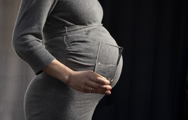 Pregnant woman with water glass