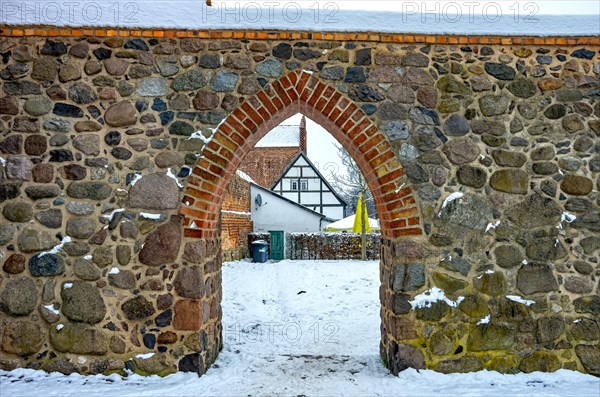 Passage or opening in the medieval city wall at Friedlaender Tor with view of architecture behind