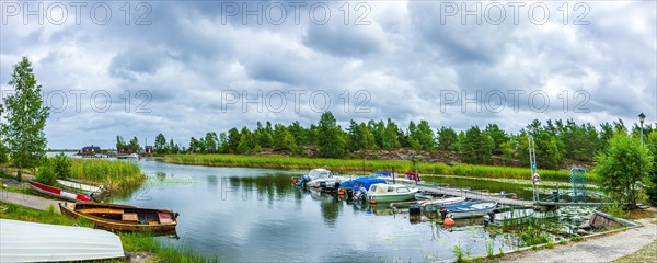 Small boats and picturesque shore landscape at the edge of Lake Vaenern in the area of Sunnana