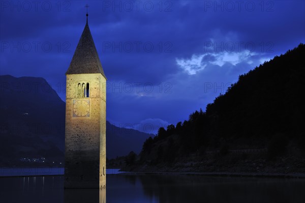 The submerged church tower at night in Lago di Resia at Curon Venosta