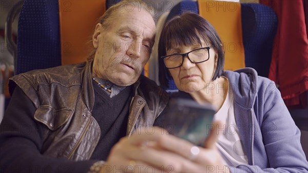 Elderly couple travel by train