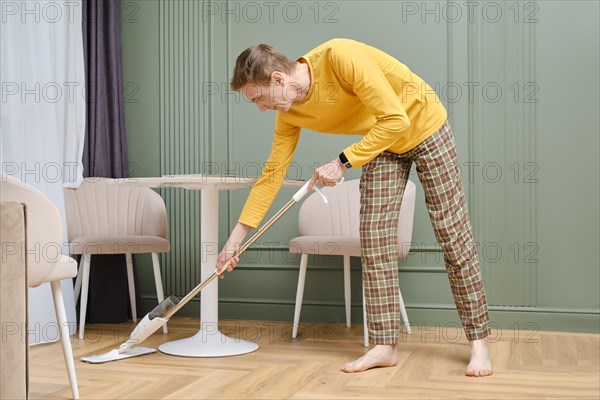 Middle aged man doing housework